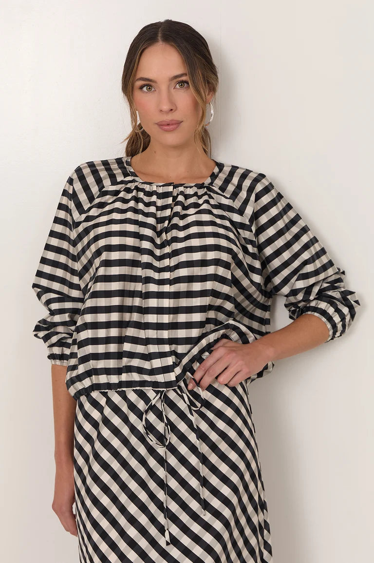 Image of Woman wearing a Adorne black and white striped dress against a plain background
