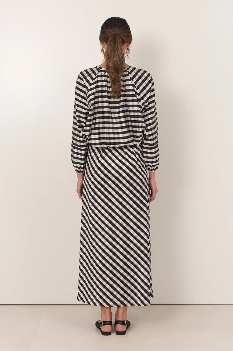 Image of Woman wearing a Adorne black and white striped dress against a plain background