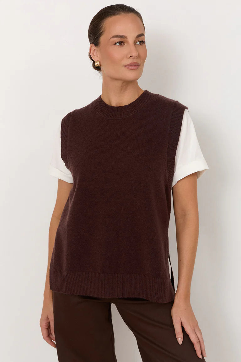 Image of Woman wearing a Adorne brown sleeveless sweater over a white shirt on a plain background