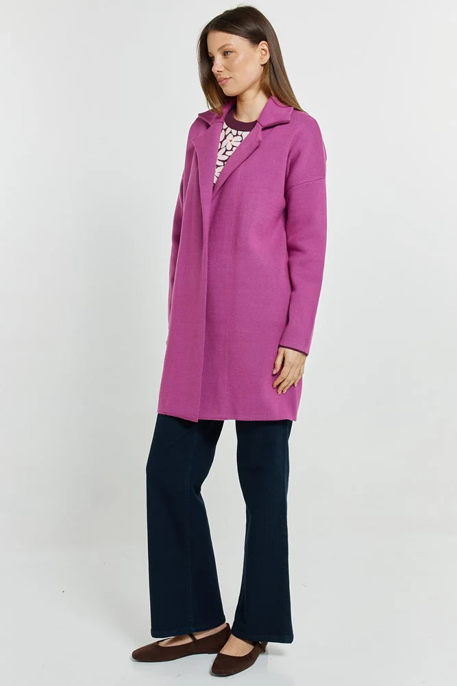 Woman wearing a Betty Basics purple coat on a white background