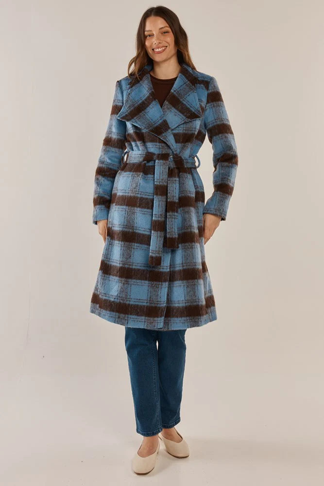 Image of Woman wearing a Betty Basics blue and brown plaid coat on a beige background