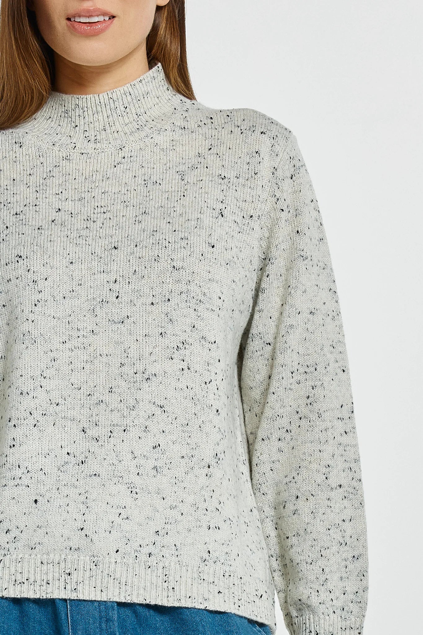 Image of Betty Basics speckled gray sweater worn by a woman on a light gray background