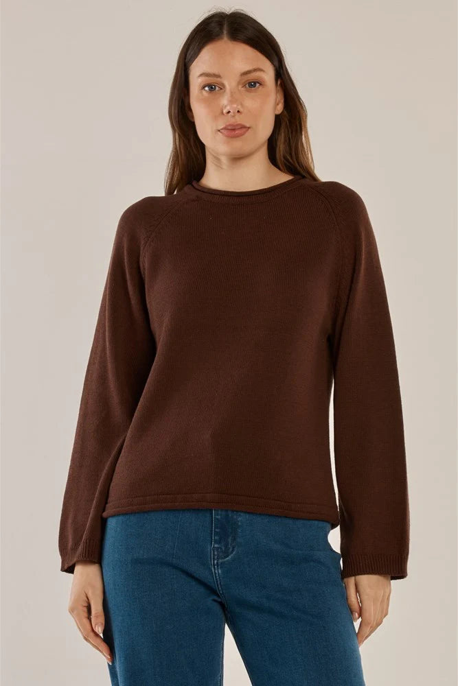 Image of Woman wearing a Betty Basics brown sweater and blue jeans against a plain background
