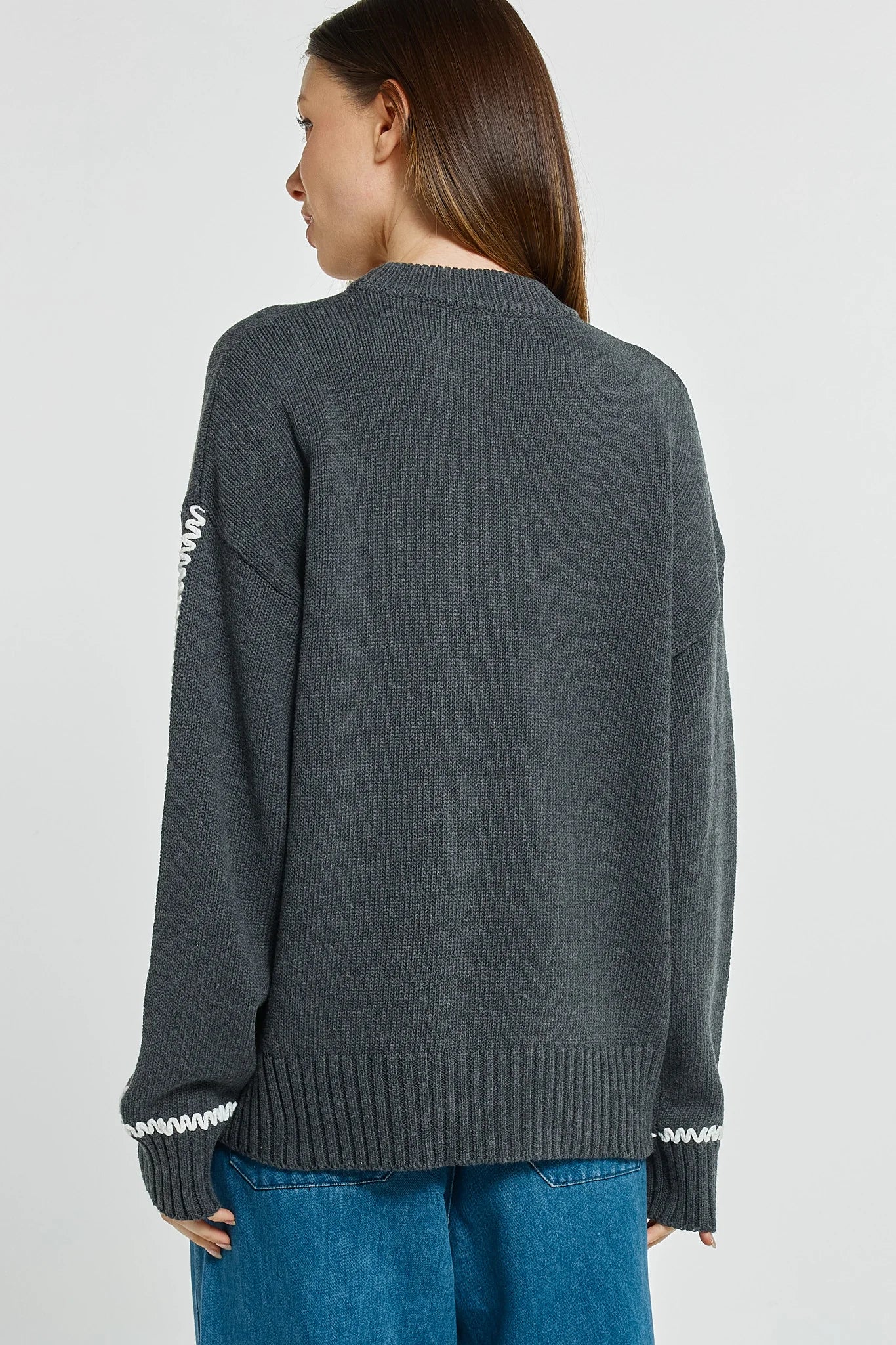 Image of Woman wearing a Betty Basics dark gray sweater with white trim on a plain background