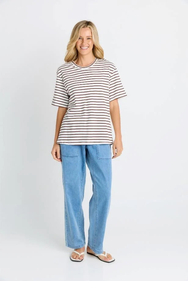 Woman wearing a Betty Basics striped shirt and blue jeans on a white background