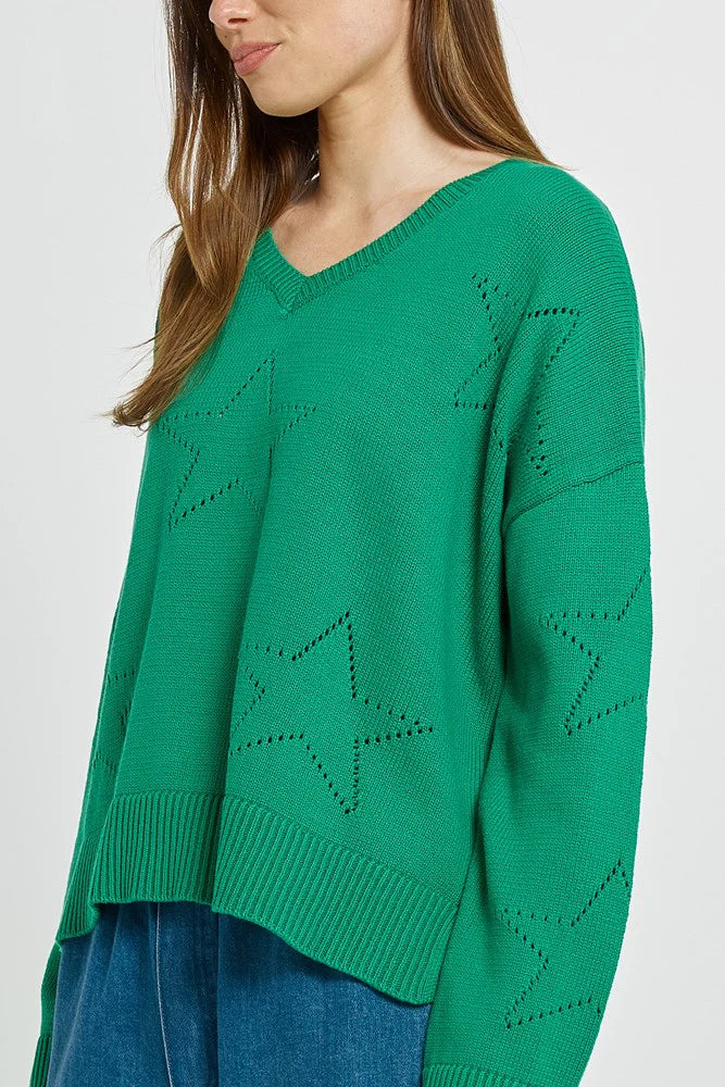 Betty Basics Green sweater with star patterns worn by a woman on a plain background