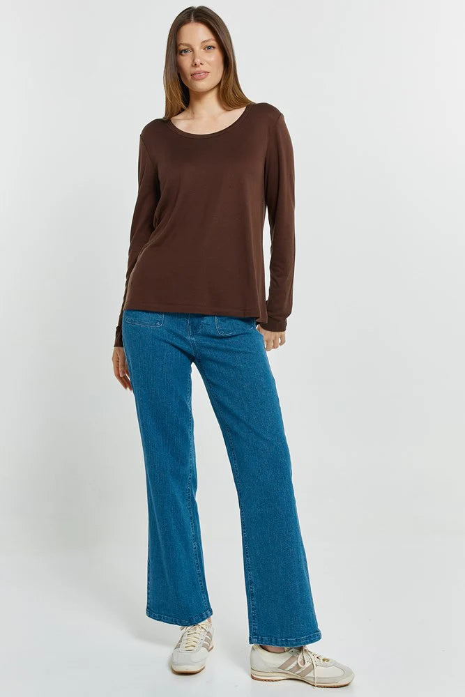 Image of Woman wearing a Betty Basics brown long-sleeve top and blue jeans on a white background