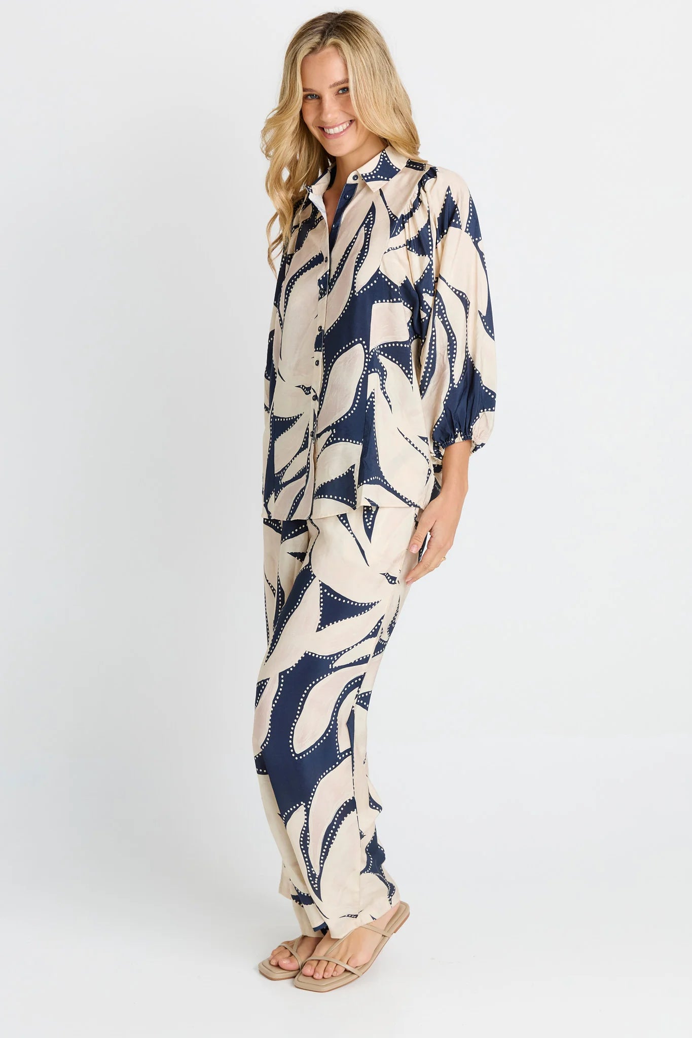 Woman wearing a long, Betty Basics patterned set on a white background