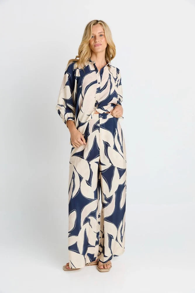 Woman wearing a Betty Basics patterned jumpsuit on a white background