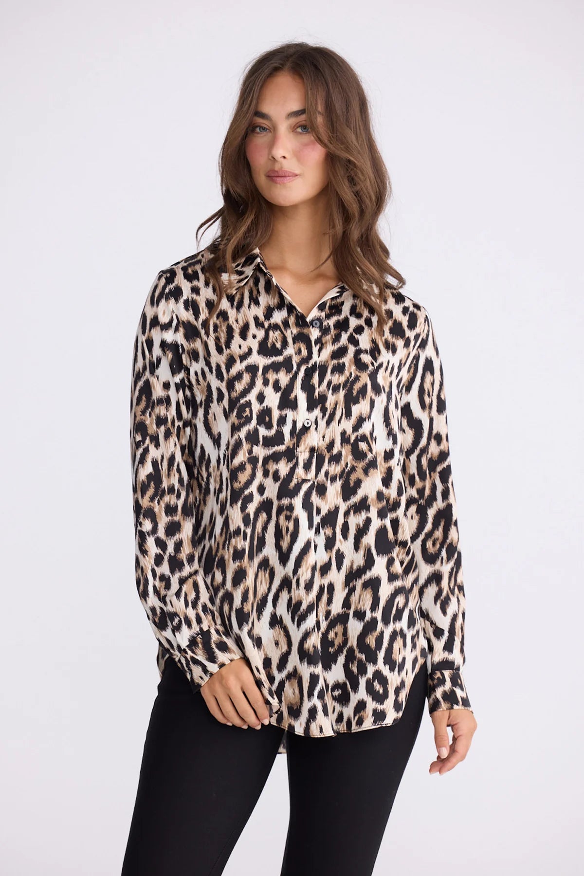 Woman wearing a Brave and True leopard print blouse on a white background