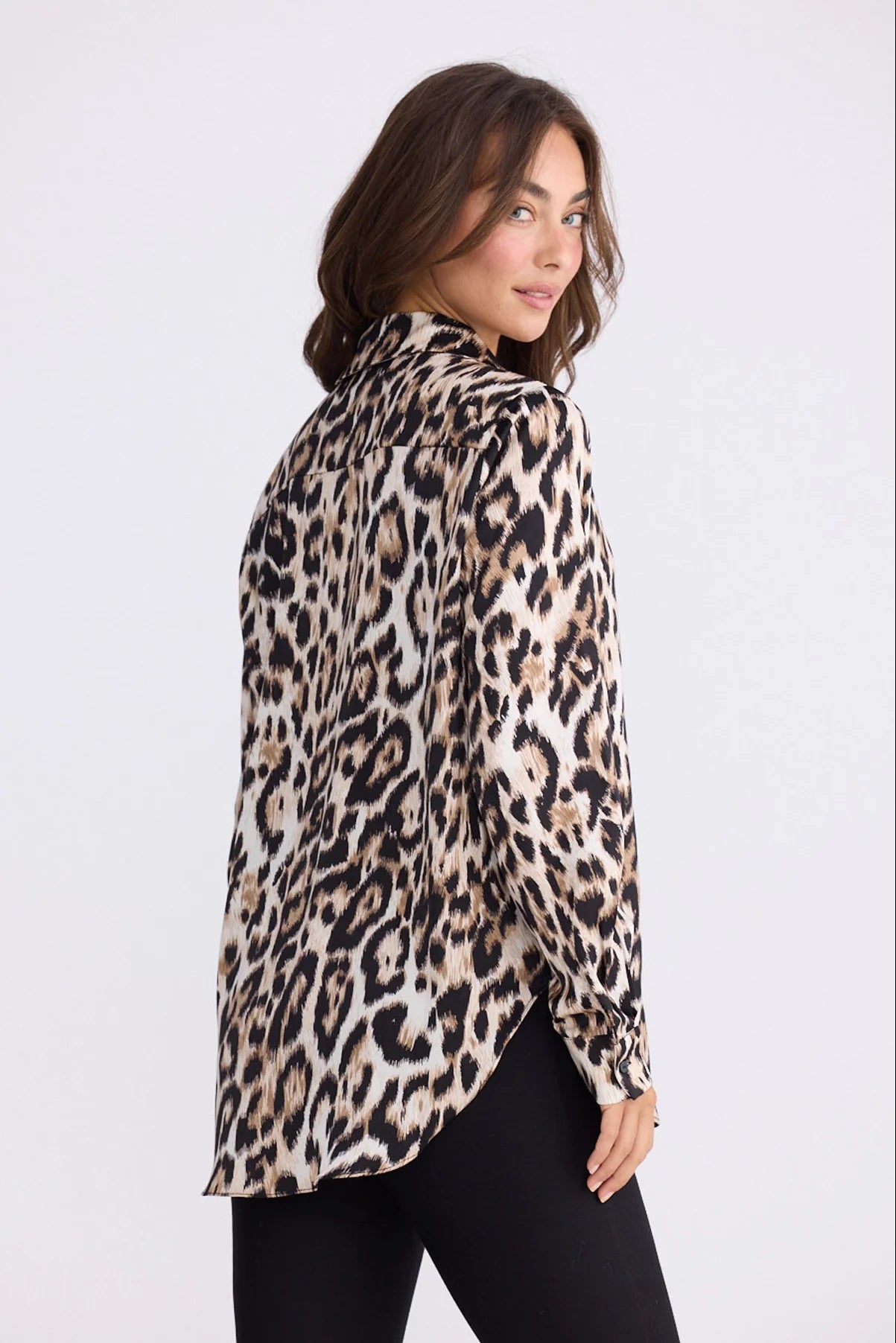 Image of Woman wearing a Brave and True leopard print shirt on a white background