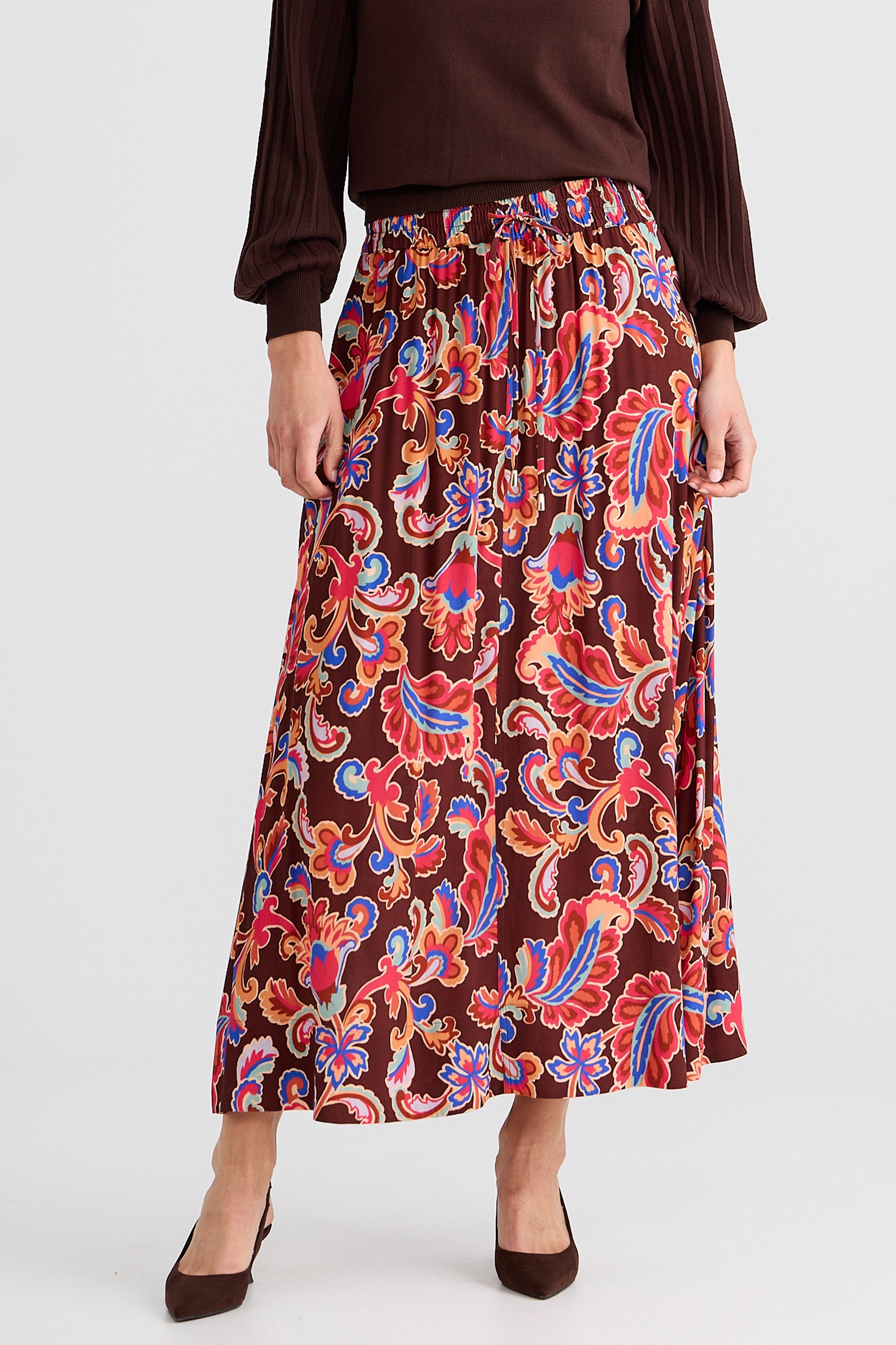 Woman wearing a Brave and True patterned skirt with a plain background