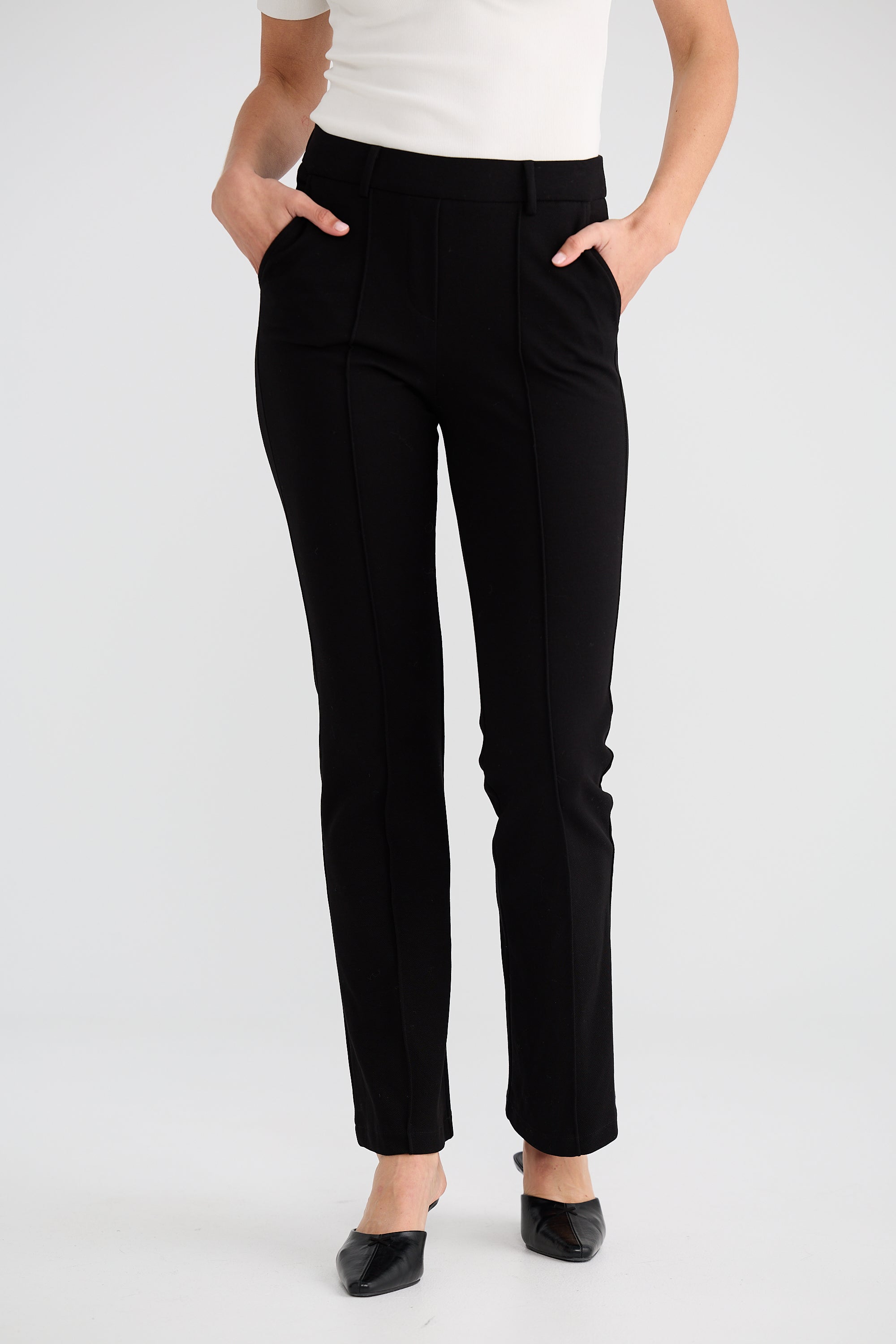 Image of Woman wearing Brave and True black pants on a white background