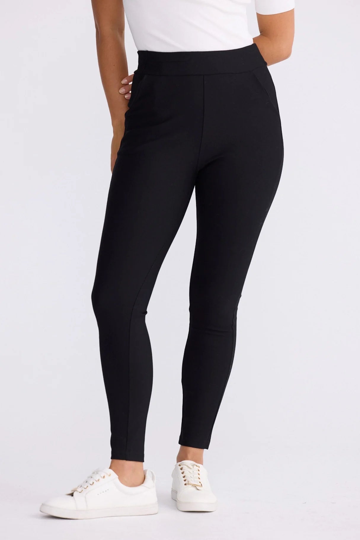 Image of Woman wearing Brave and True black leggings with a white background