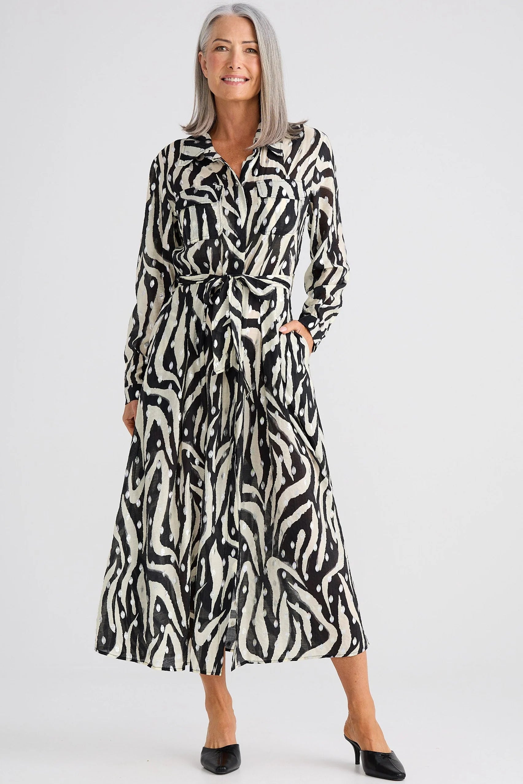 Woman wearing a Brave and True zebra print dress on a white background