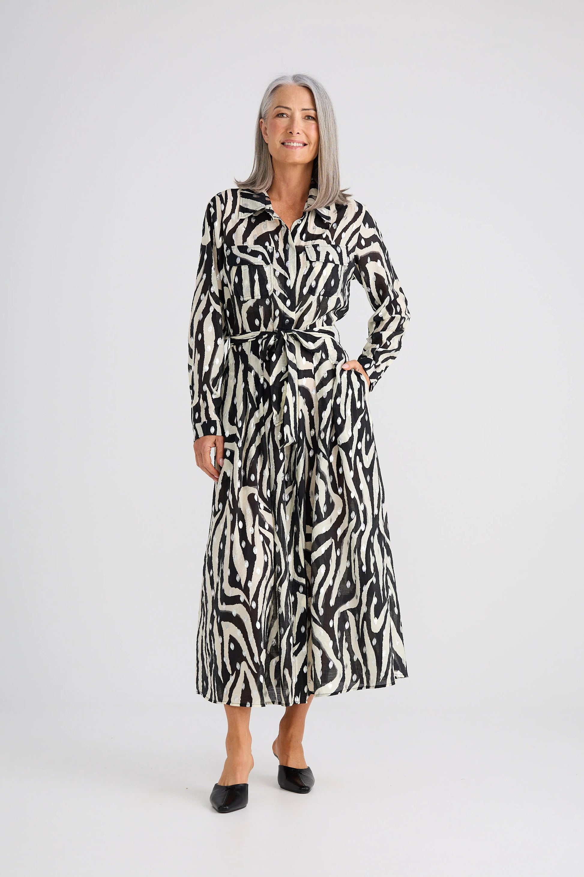 Woman wearing a Brave and True zebra print dress on a white background