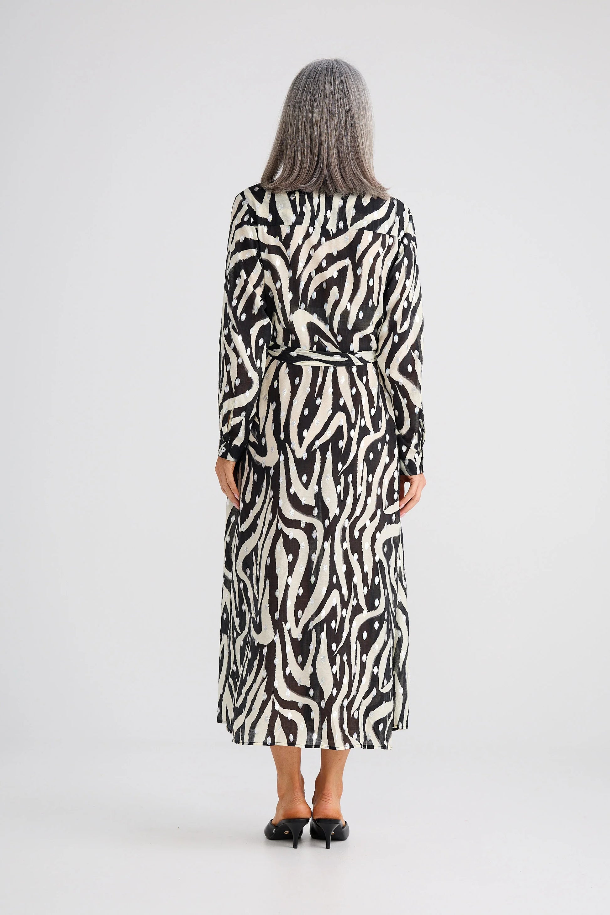 Woman wearing a Brave and True zebra print dress on a white background