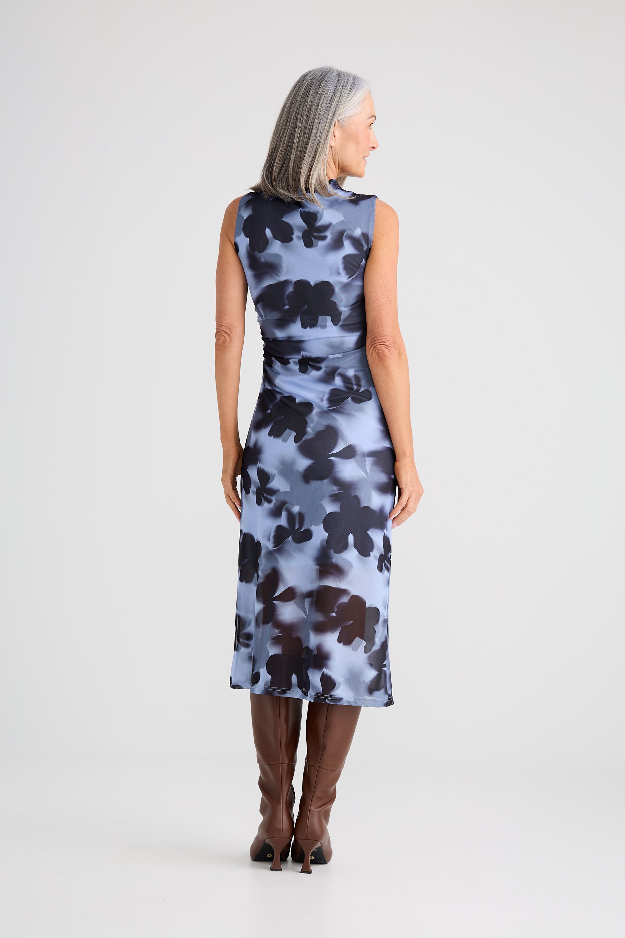Image of Woman wearing a Brave and True sleeveless floral dress on a white background