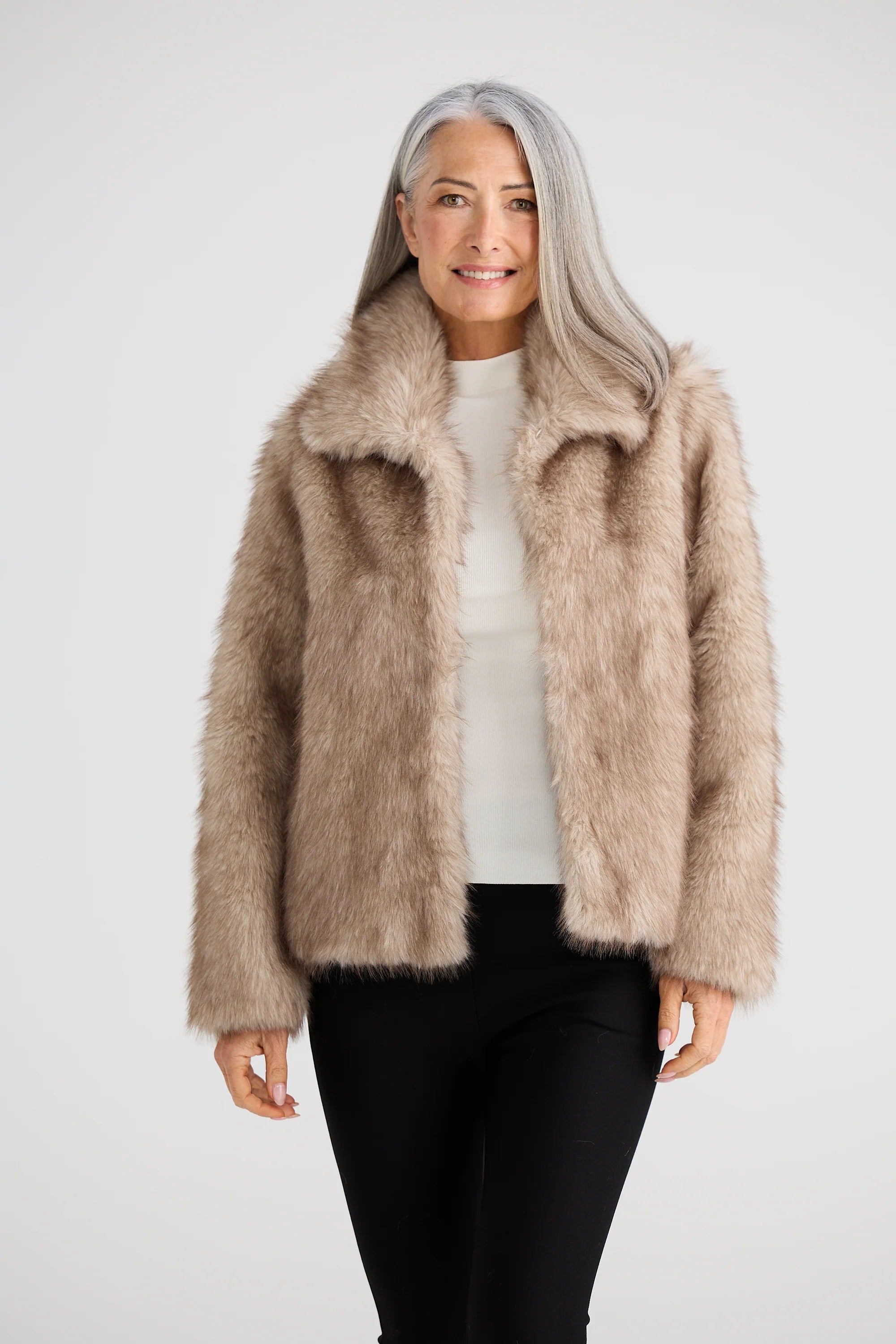 Image of Woman wearing a Brave & True beige fluffy jacket on a white background