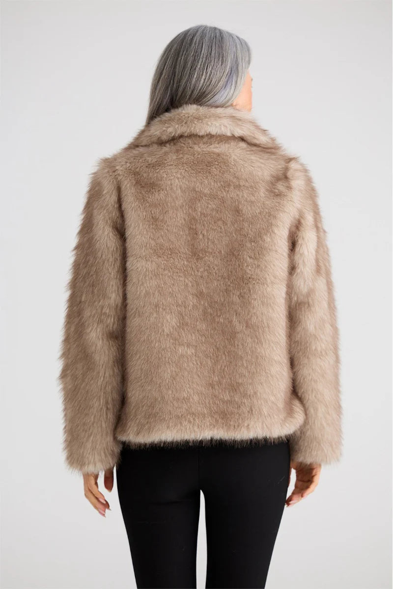 Image of Woman wearing a Brave & True beige faux fur jacket on a white background