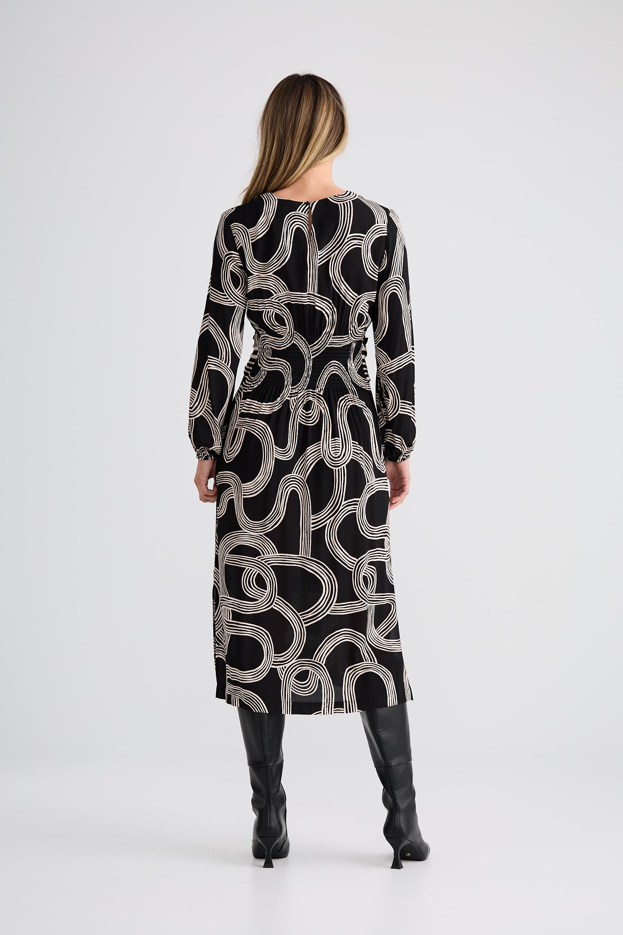 Image of Woman wearing a Brave and True black and white patterned dress on a white background