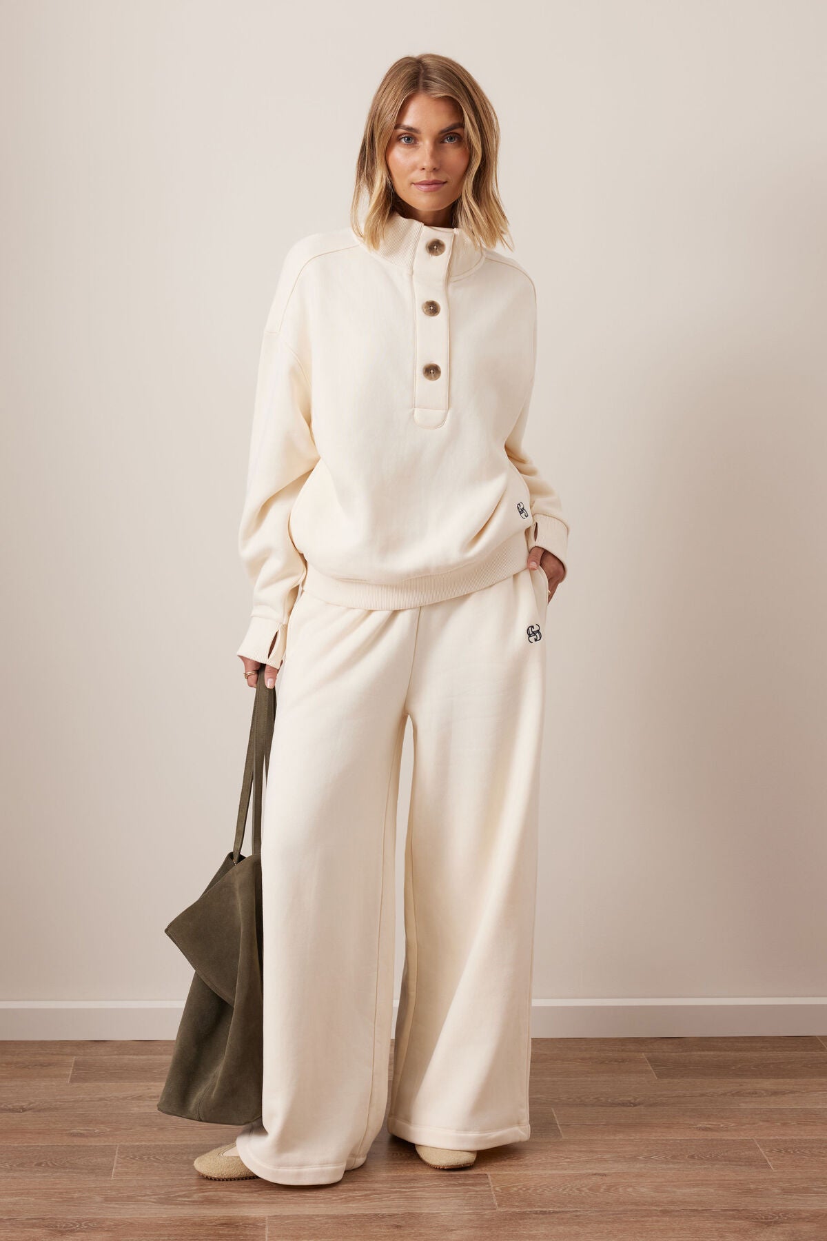 Image of Woman wearing a Ceres Life cream-colored outfit with wide-leg pants against a plain background