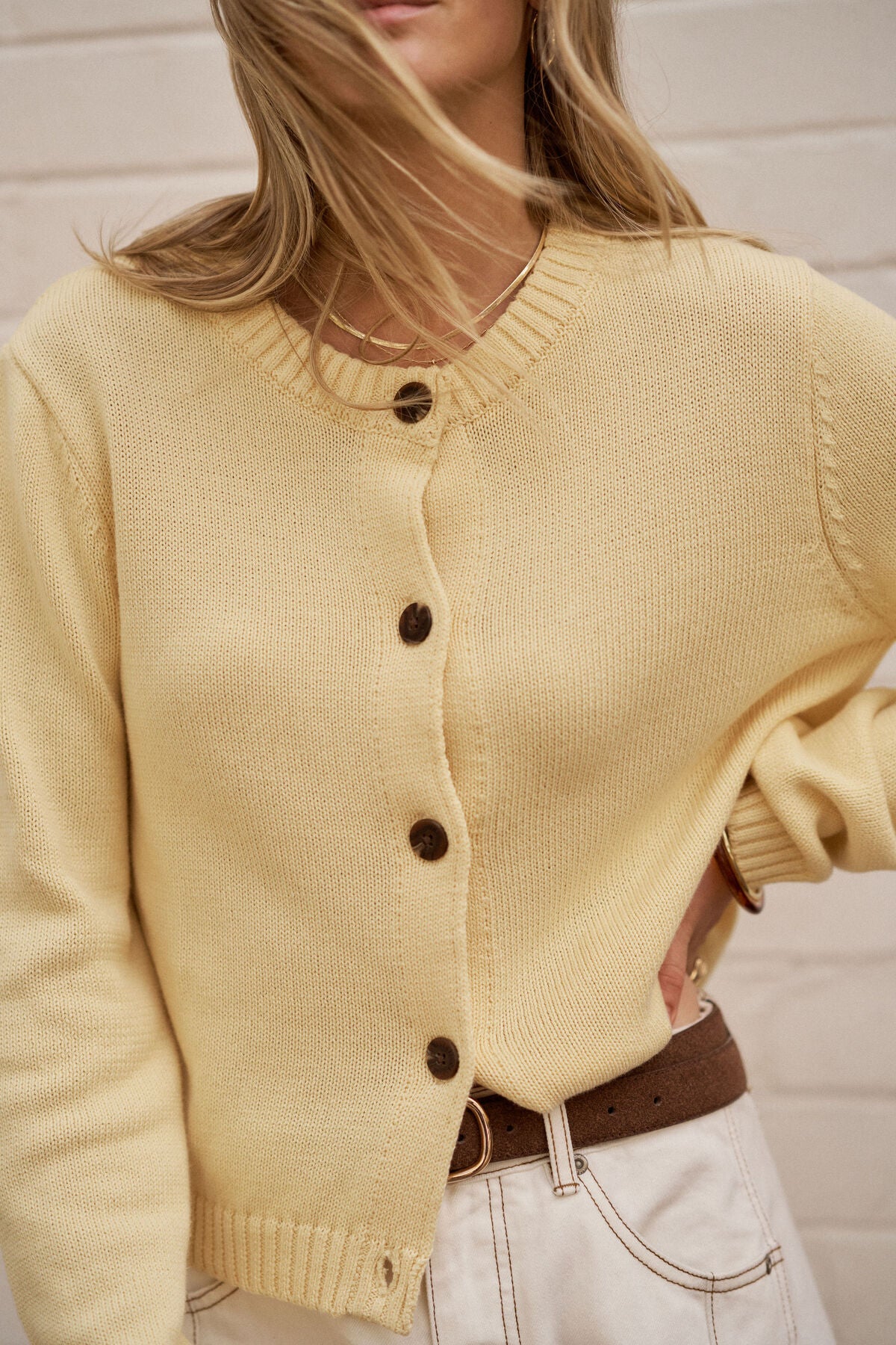 Image of Woman wearing Ceres Life wearing a yellow cardigan with a neutral background