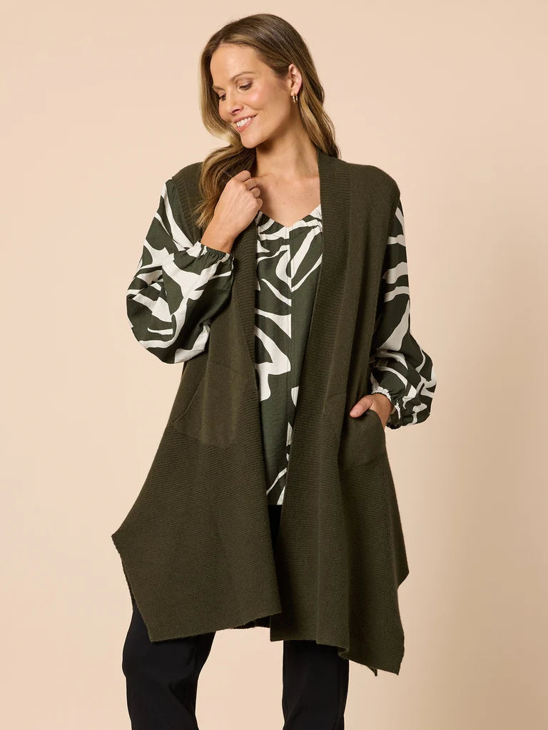 Collection of Woman wearing a Clarity long olive green cardigan over a patterned top on a beige background in a gallery layout