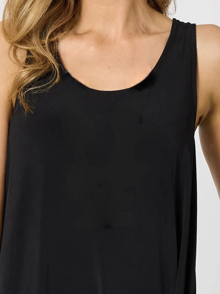 A close-up of a woman wearing a Clarity black sleeveless scoop-neck tank top against a light gray background.