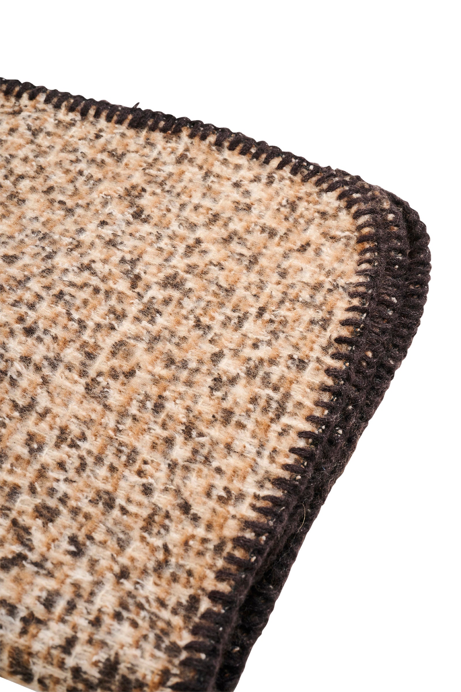 Close-up of a textured eb & ive brown and black scarf corner on a white background