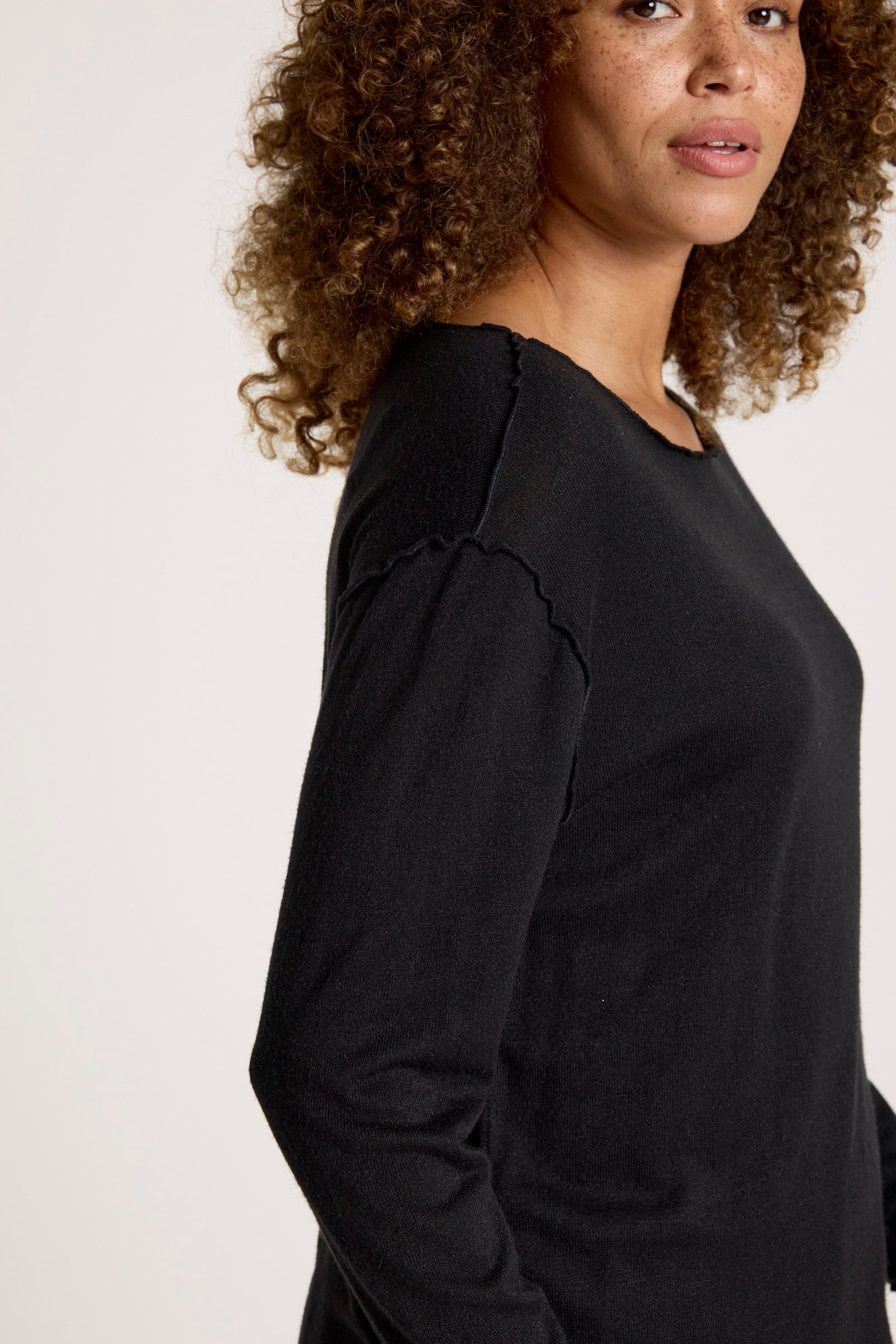 Image of Woman wearing a Eb & Ive black long-sleeve top against a plain background