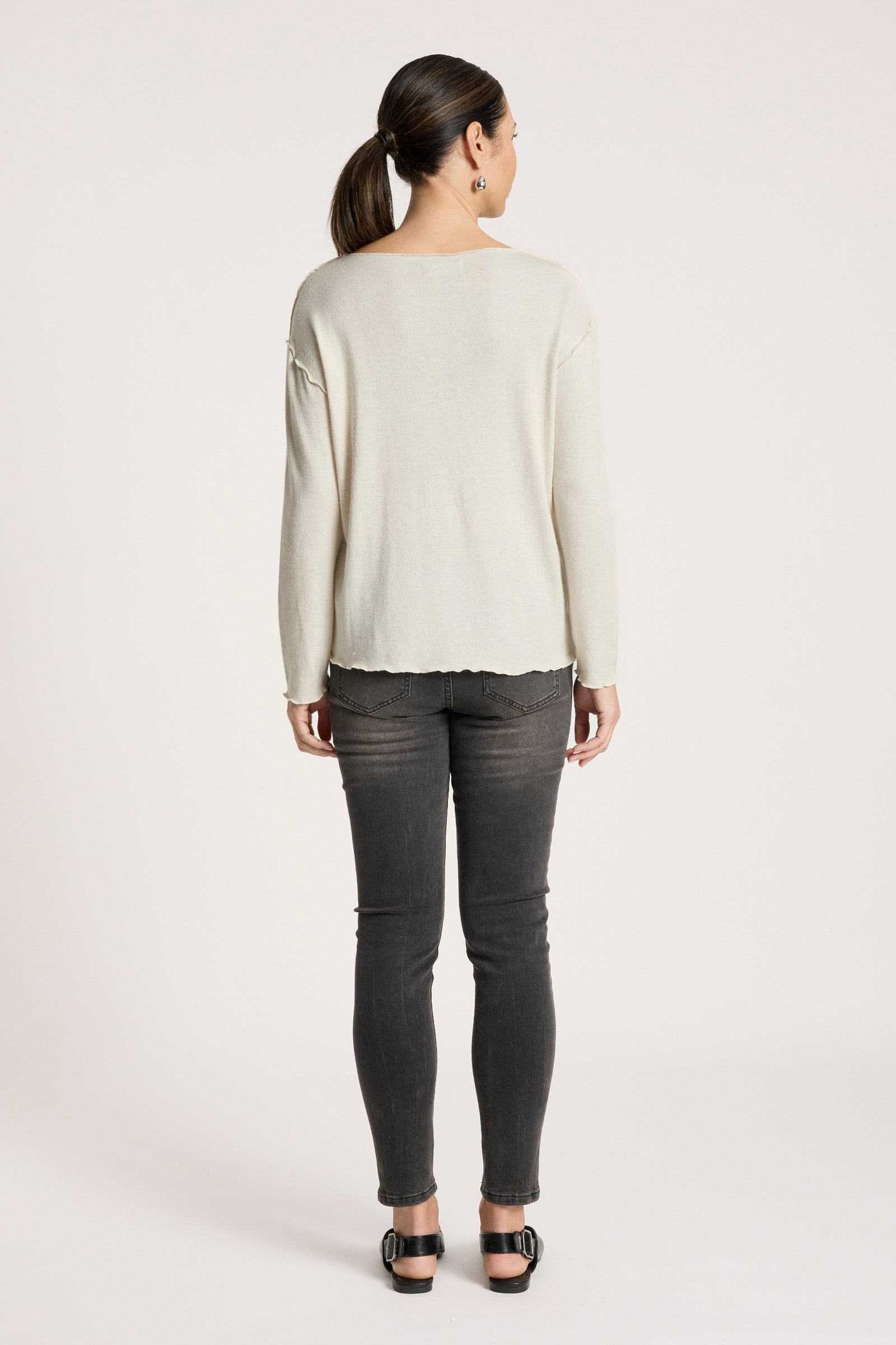 Image of Woman wearing a Eb & Ive light-colored long-sleeve top and dark gray pants on a white background