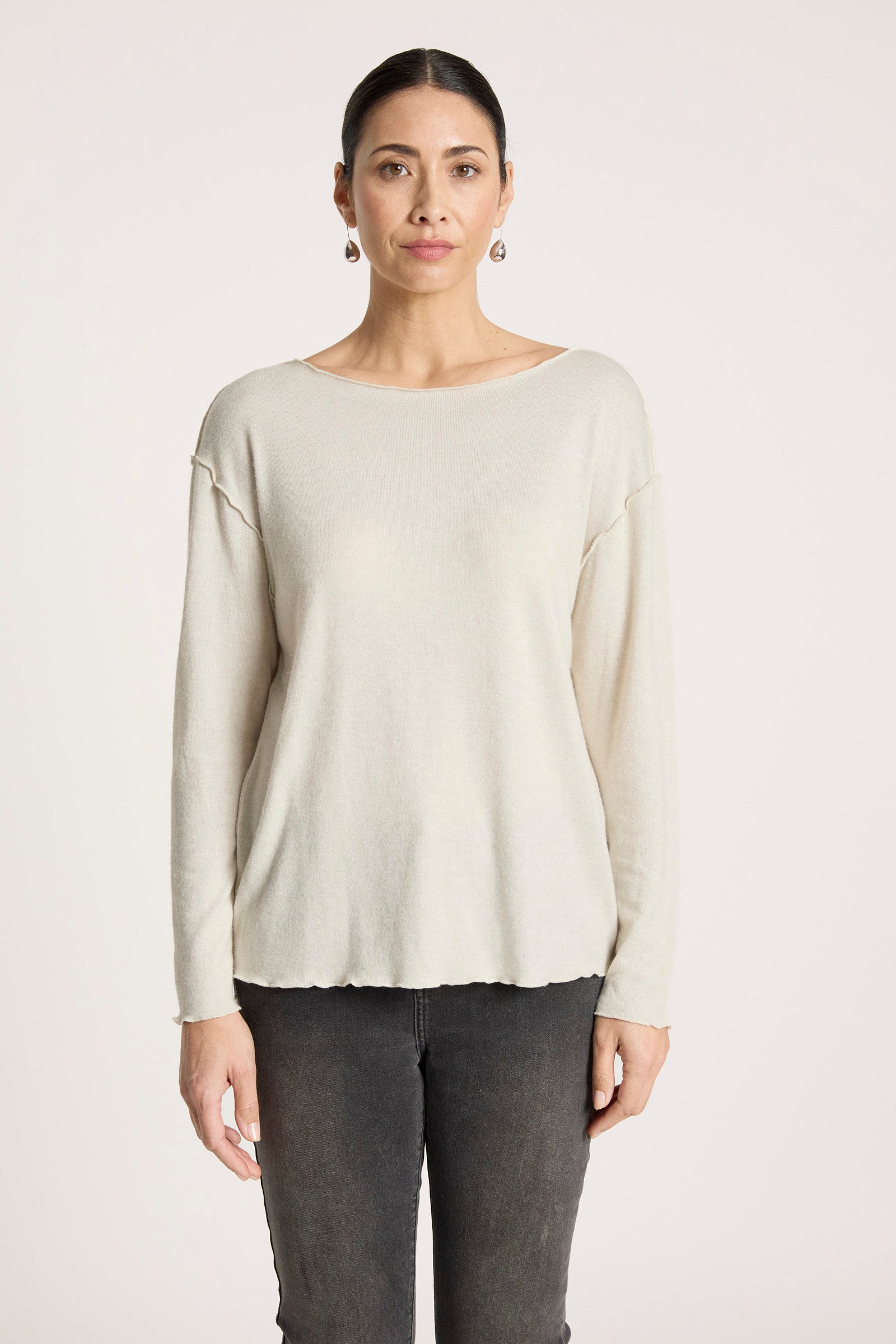 Image of Woman wearing a Eb & Ive beige sweater and dark pants on a white background