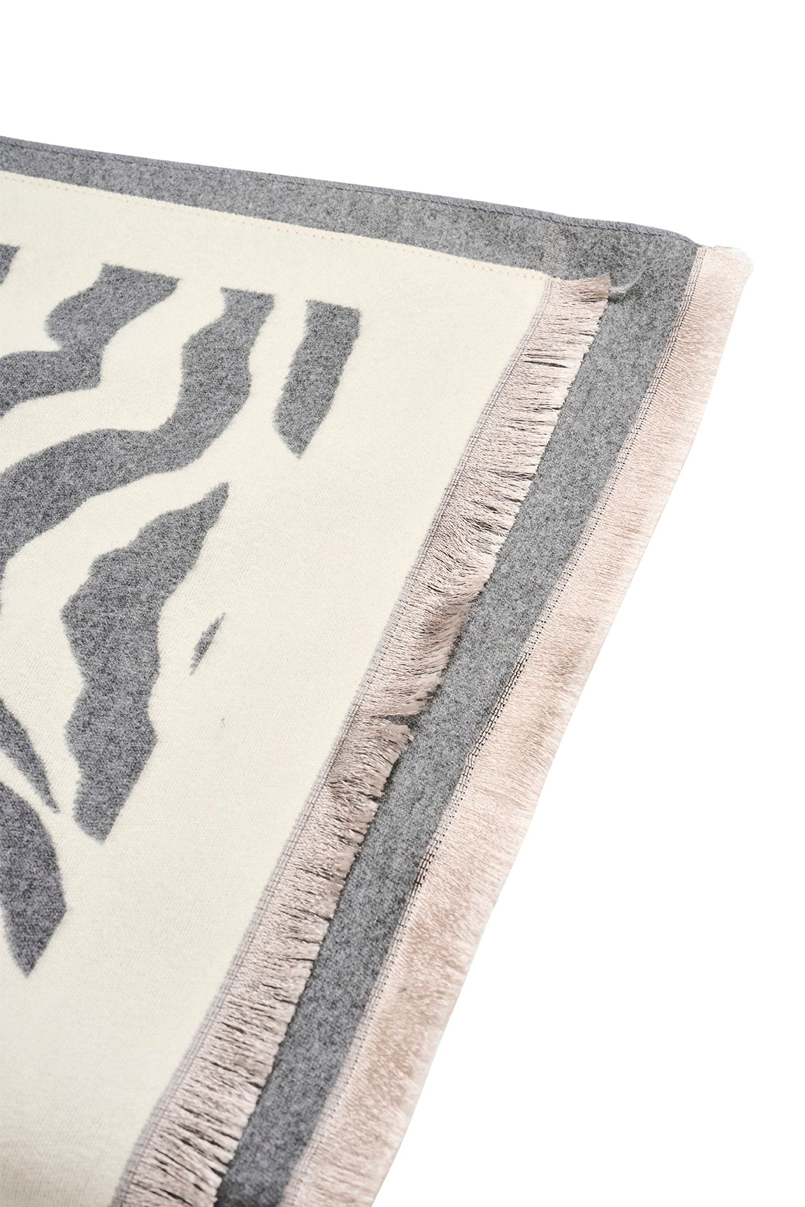 Image of Eb & Ive Close-up of a scarf with a leaf pattern and fringe detail on a white background