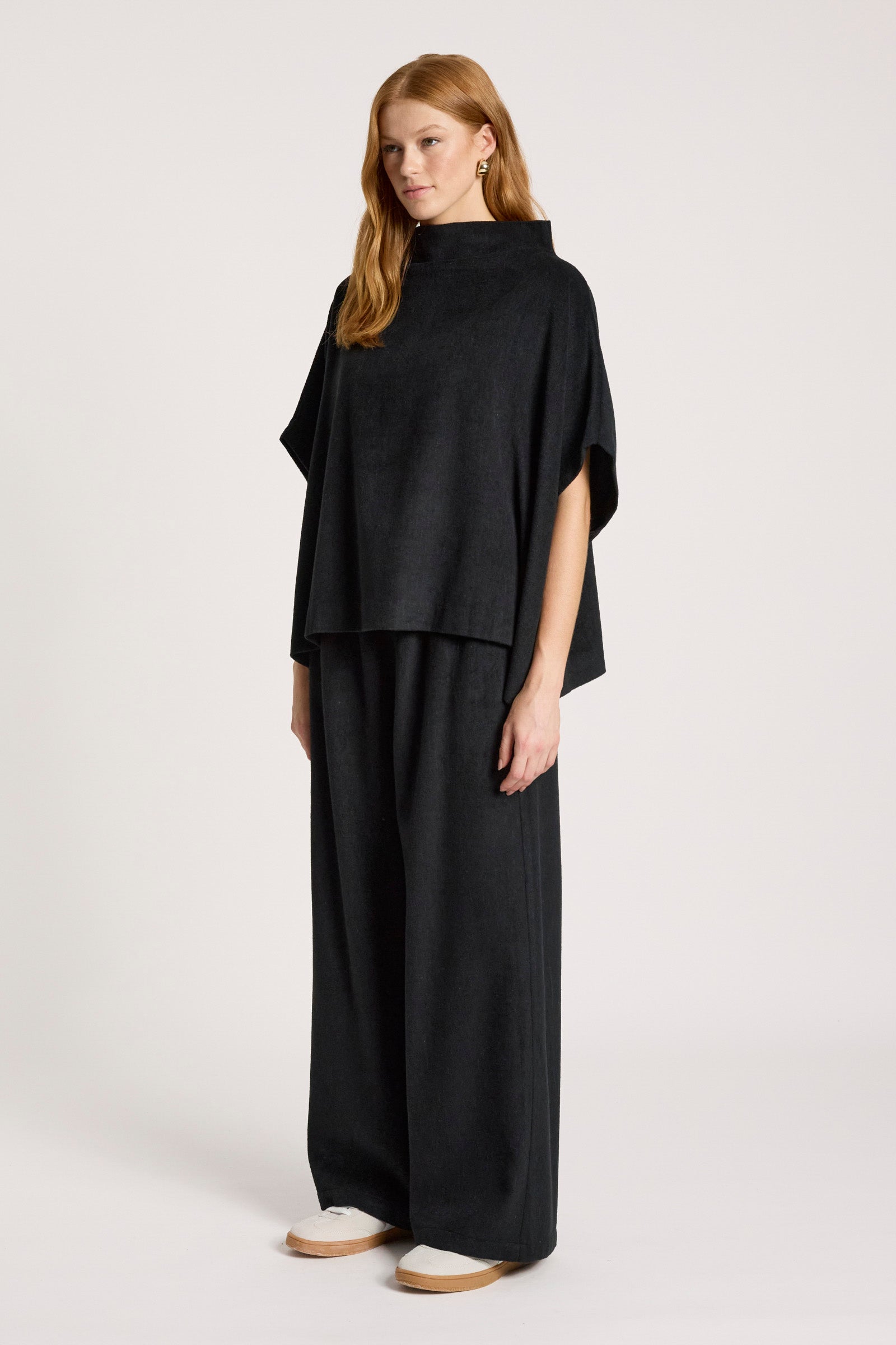 Image of Woman wearing a Eb and Ive black outfit on a white background