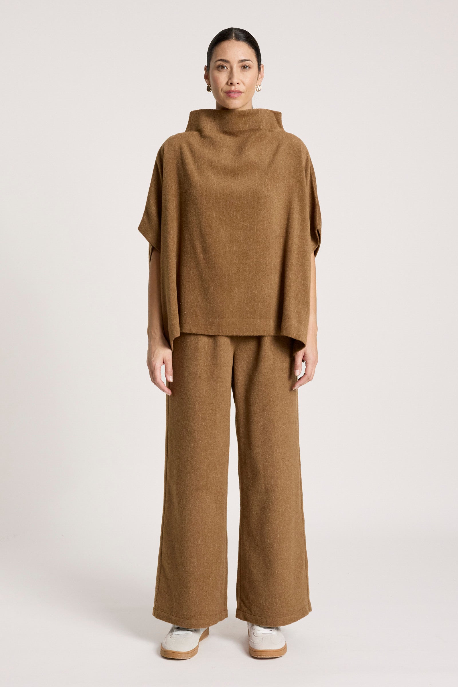 Image of Woman wearing a Eb & Ive brown outfit with a cowl neck top and wide-leg pants on a white background