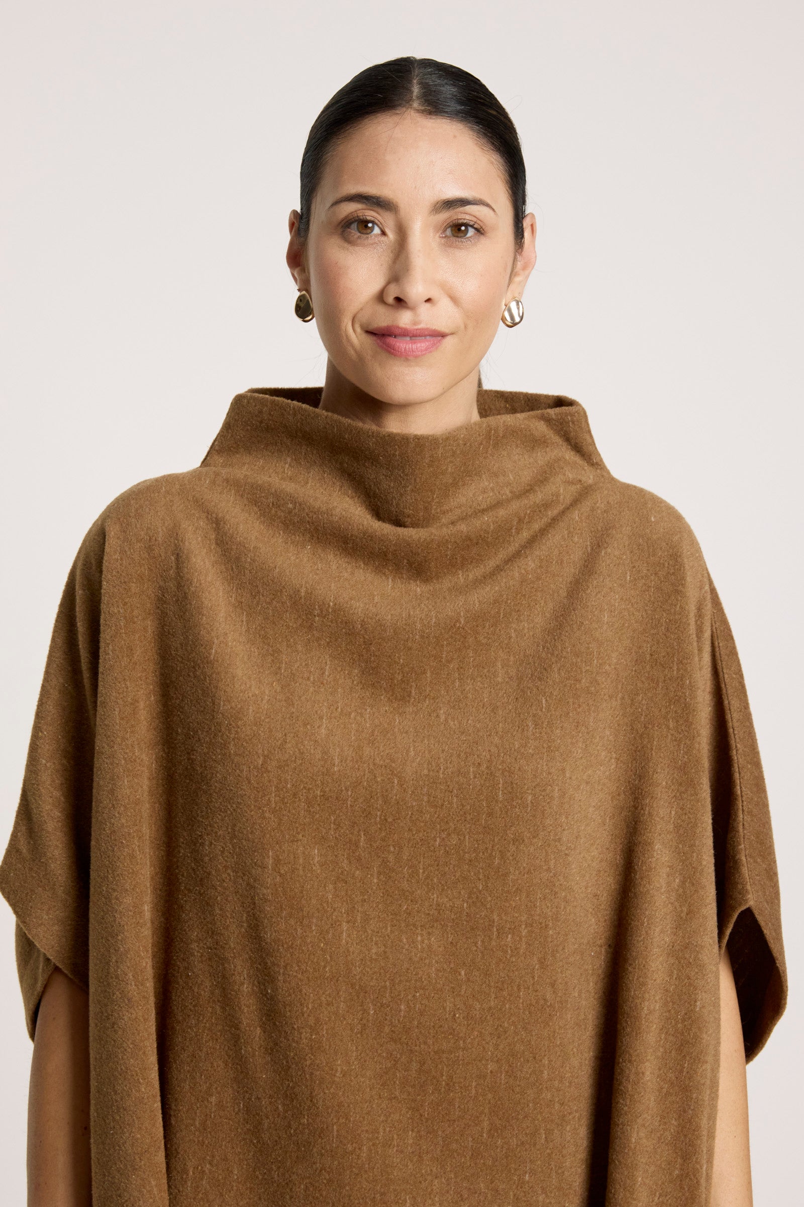 Image of Woman wearing a Eb & Ive brown poncho against a white background