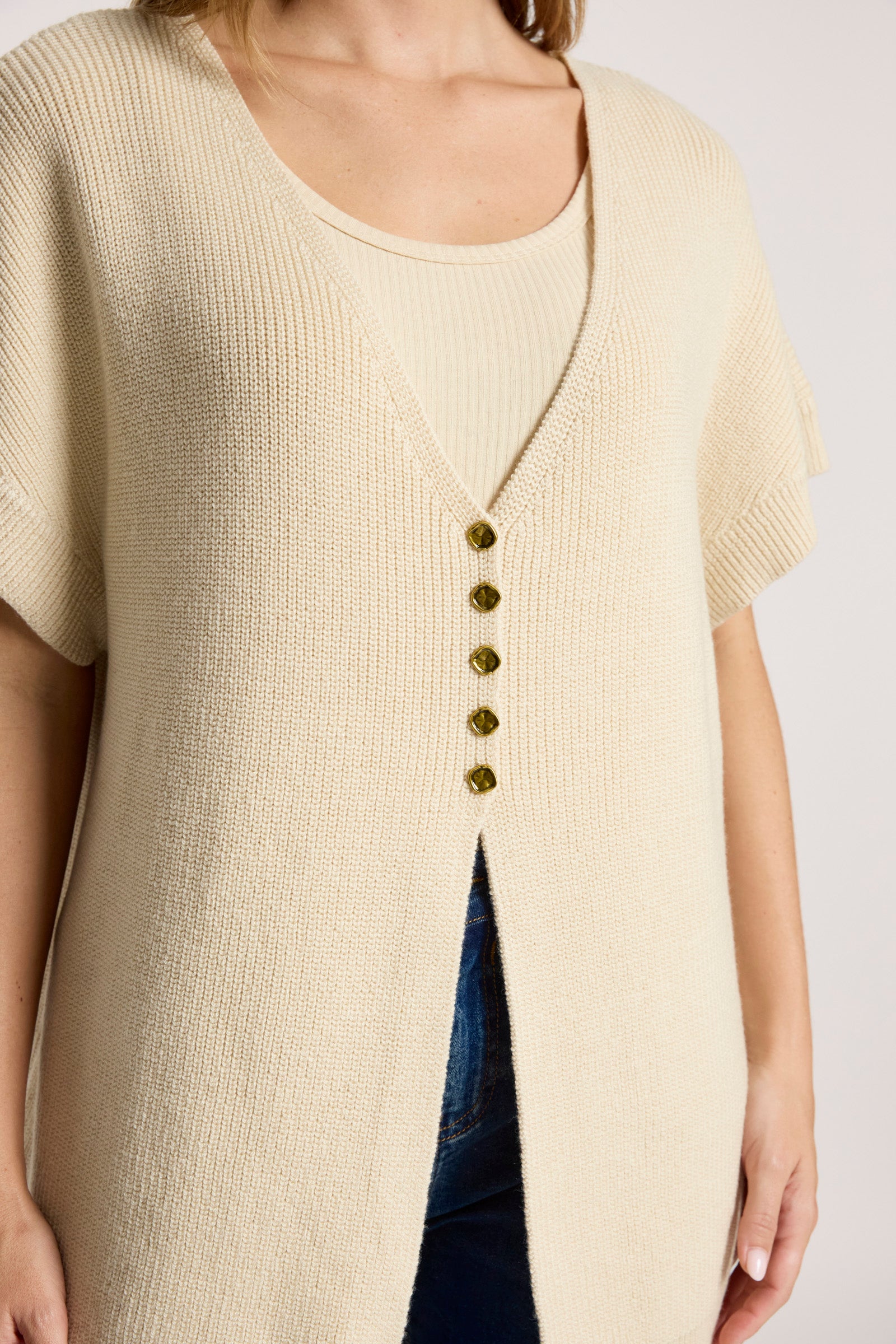 Image of Woman wearing  Eb and Ive Beige knit top with button details on a plain background