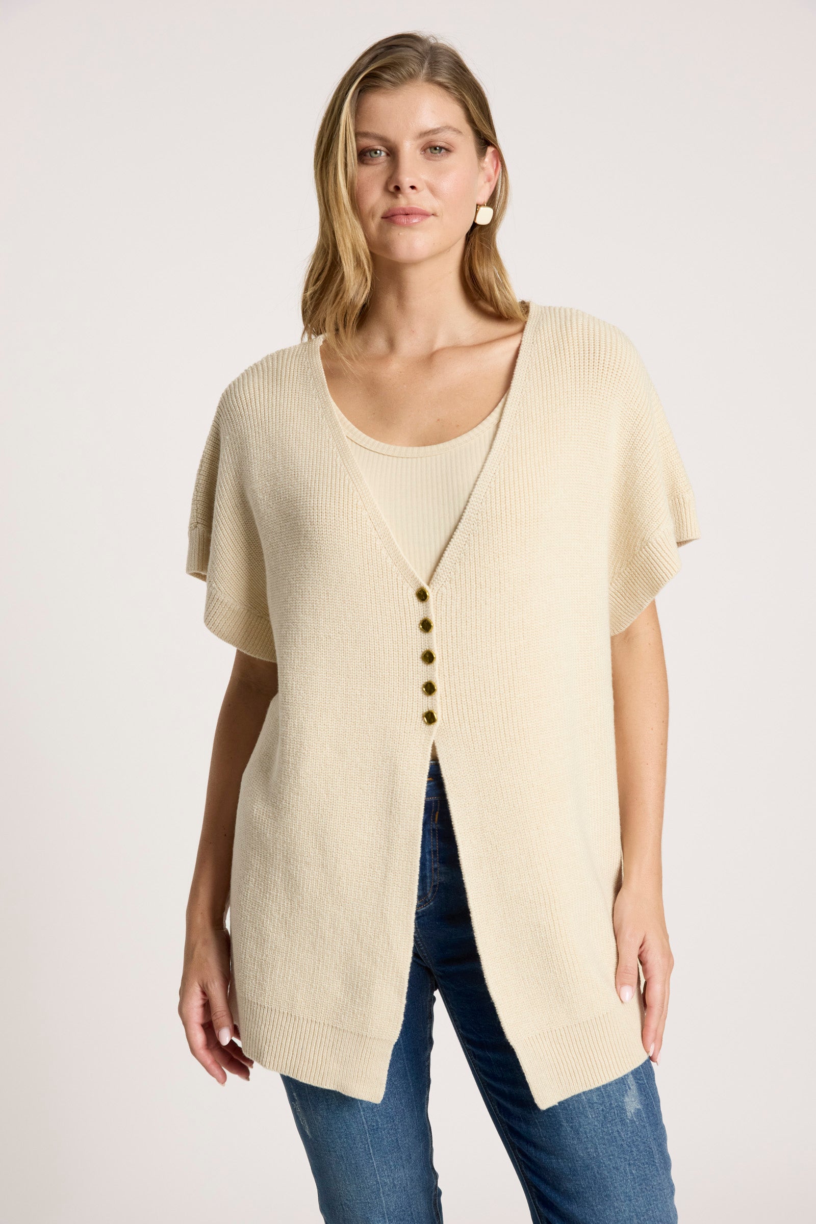 Image of Woman wearing a Eb & Ive beige cardigan with buttons on a white background