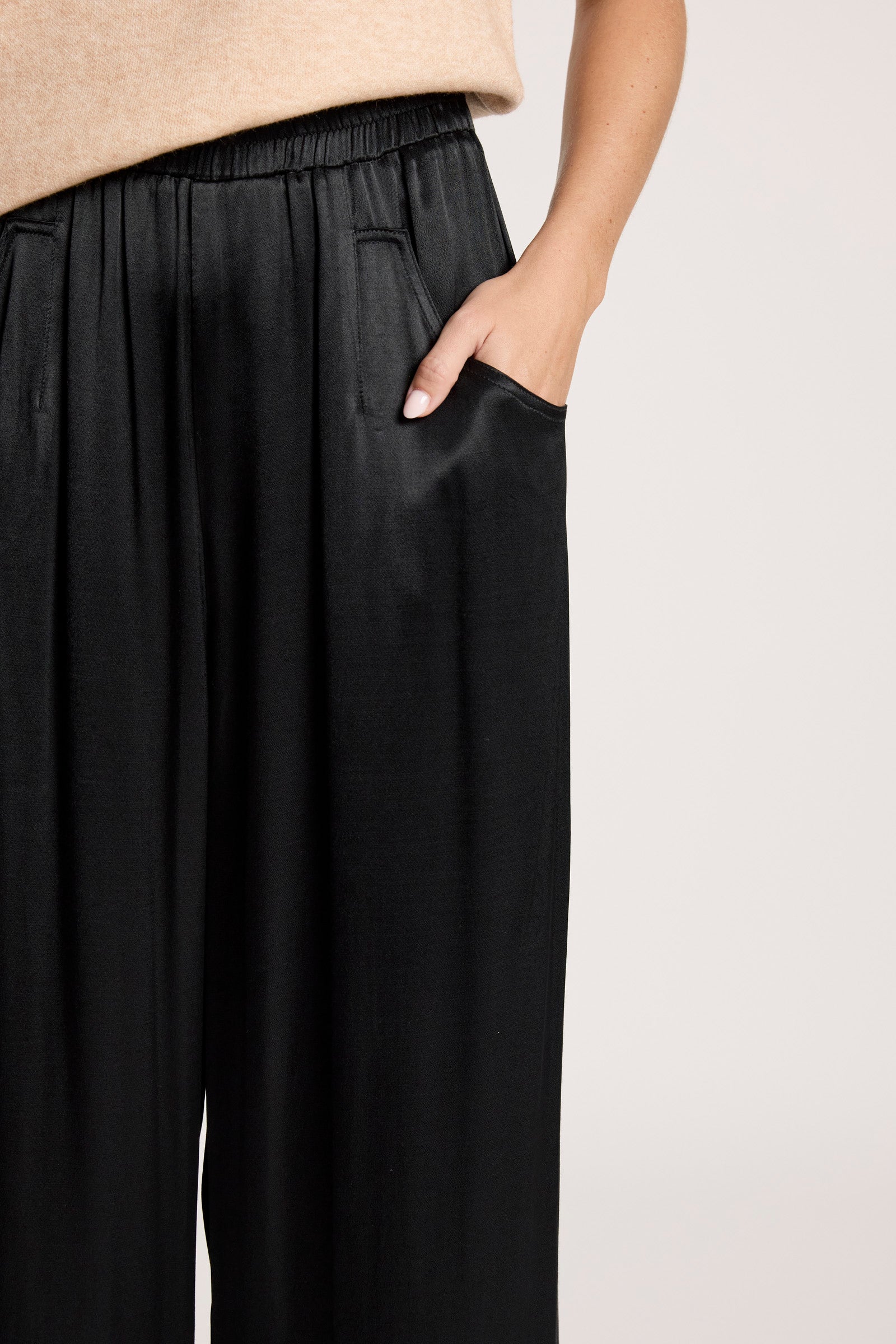 Image of Woman wearing Eb & Ive black pants with a neutral background