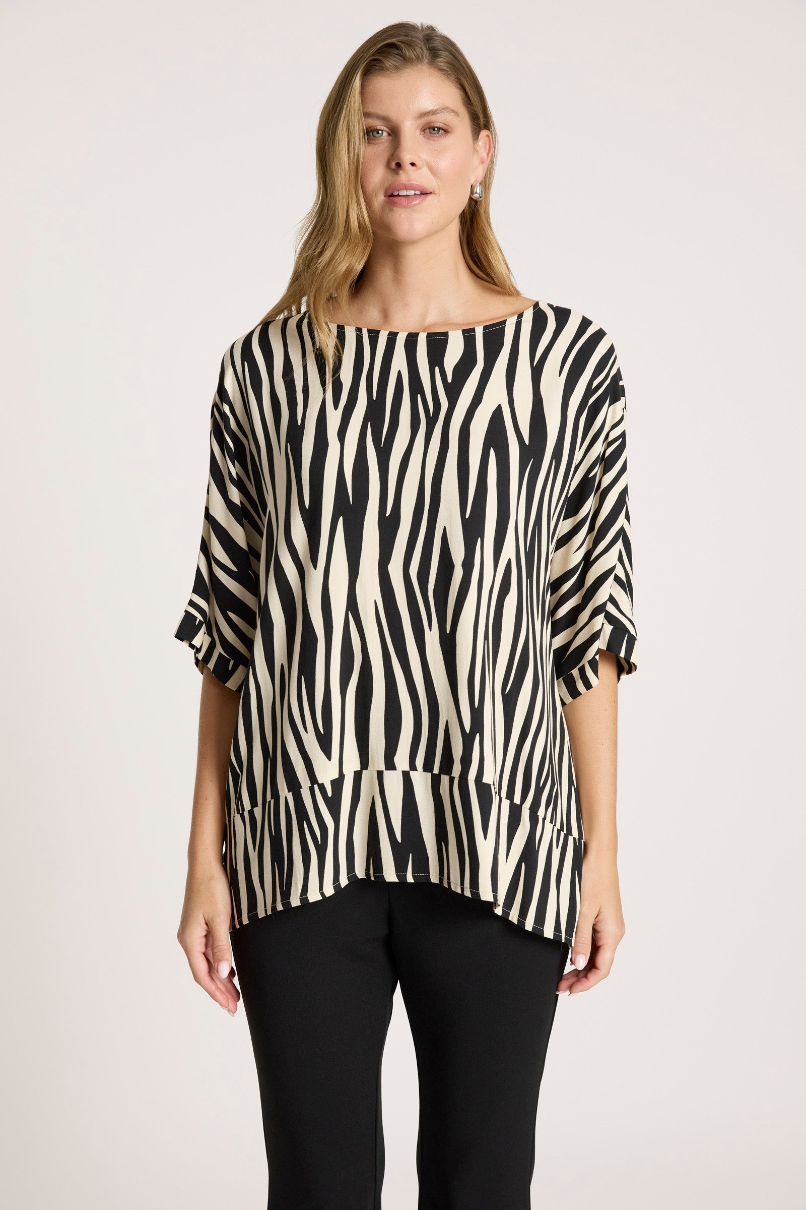 Image of Woman wearing a Eb & Ive black and white patterned top against a plain background