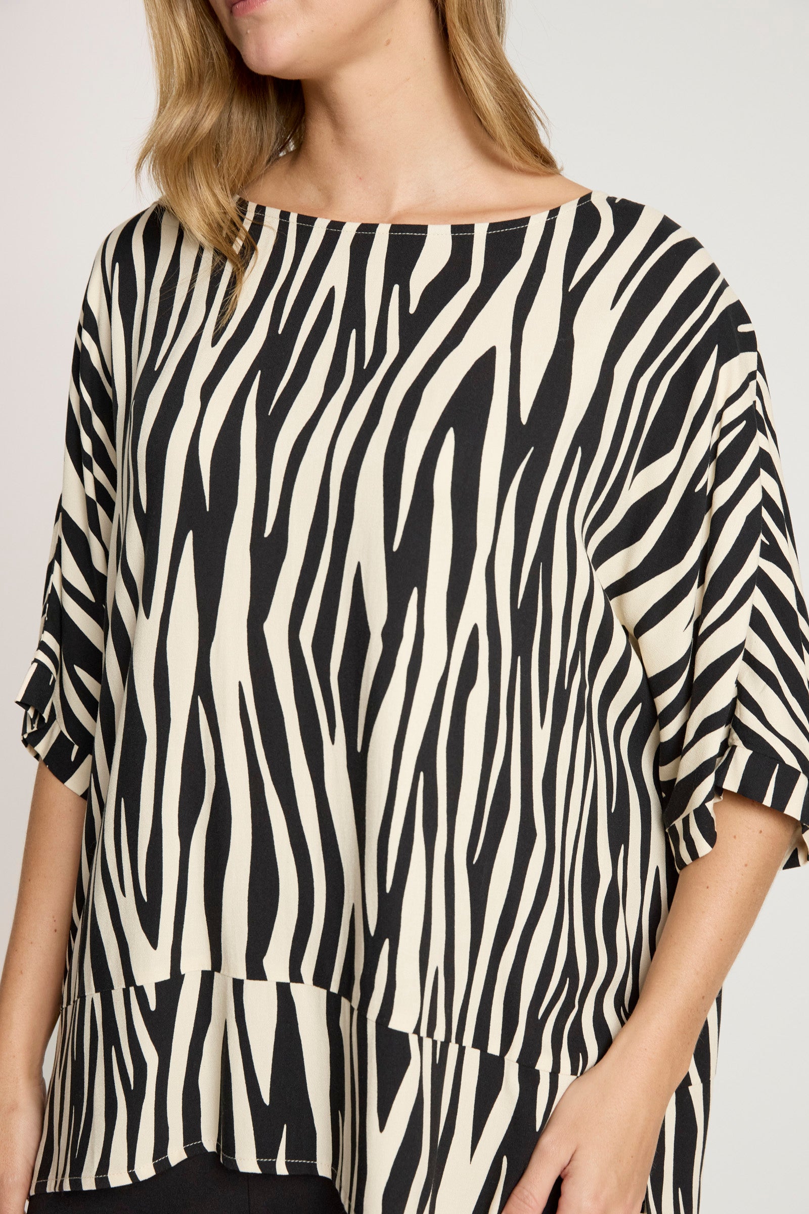 Image of Woman wearing a Eb & Ive zebra print top on a plain background