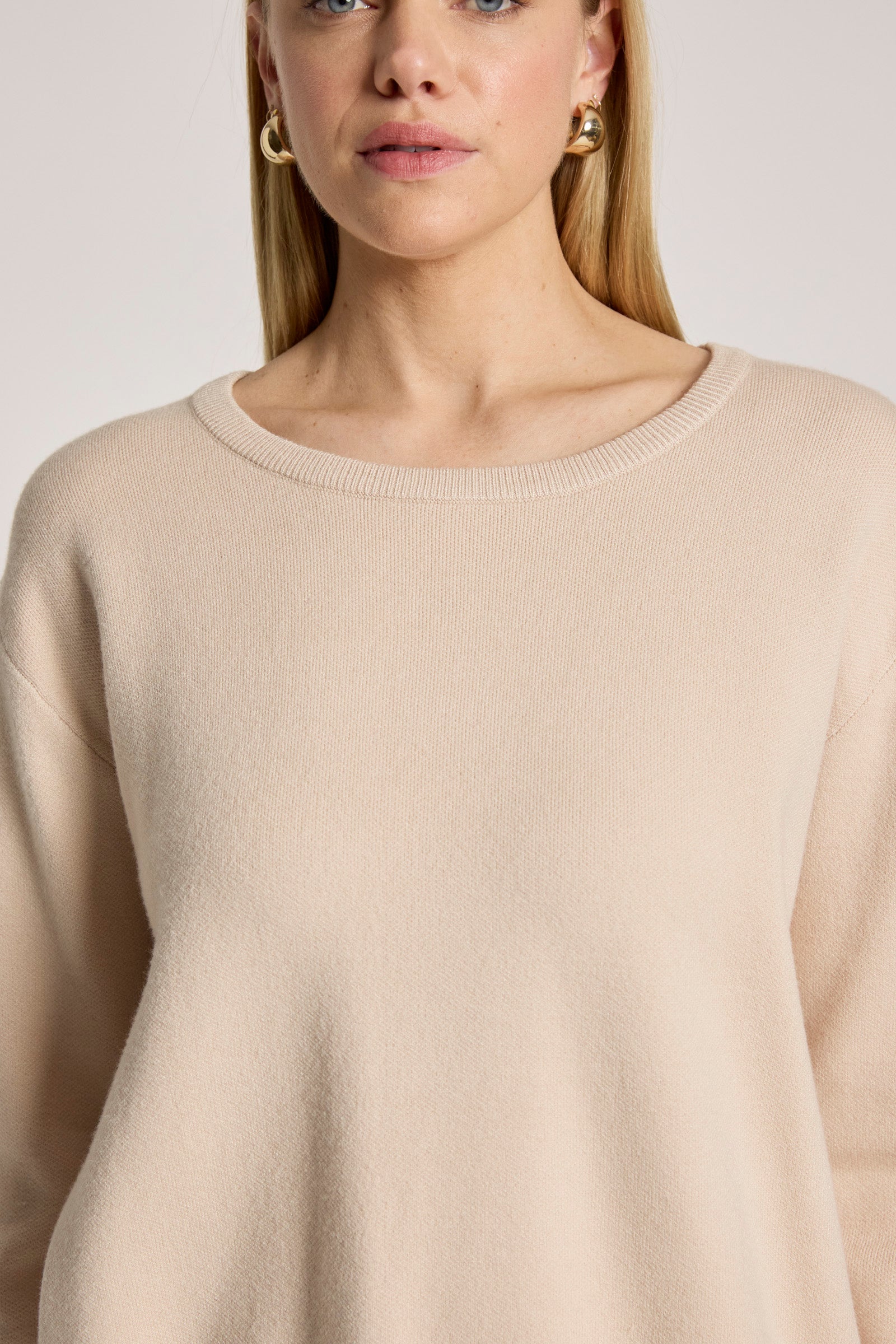 Image of Eb and Ive Beige sweater worn by a person on a plain background
