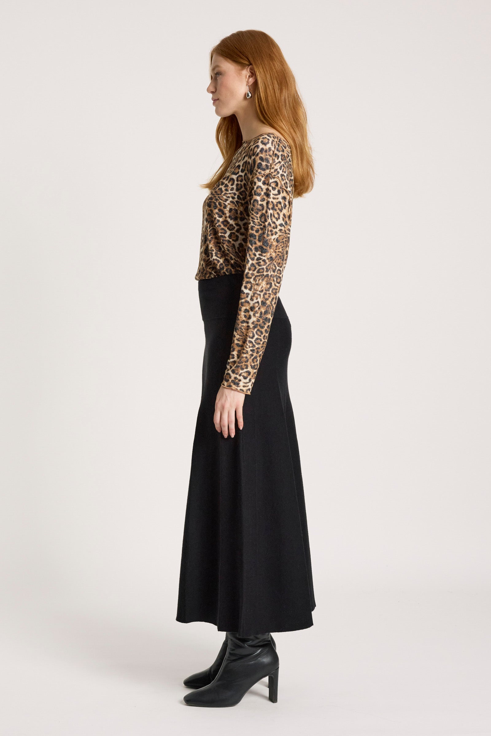 Image of Woman wearing a leopard print top and Eb & Ive black skirt on a white background