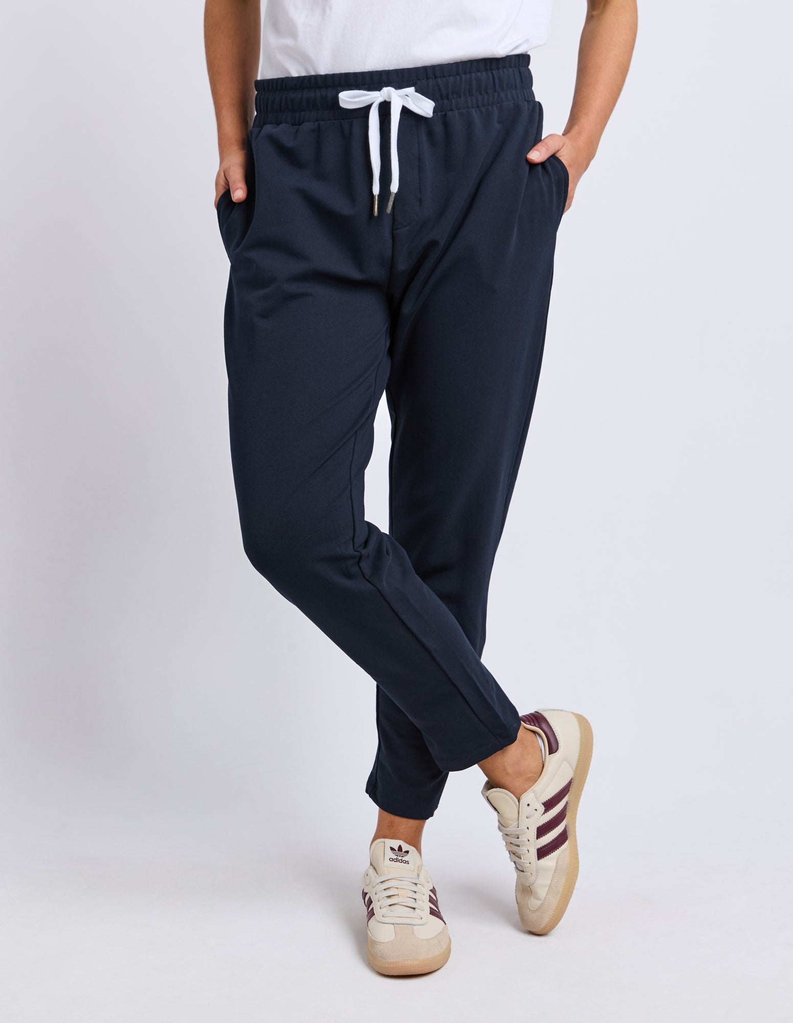 Elm Navy jogger pants worn by a woman on a white background