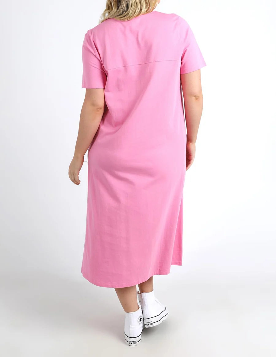 A woman wearing a Elm pink short-sleeve midi dress, shown from the back against a plain white studio background.