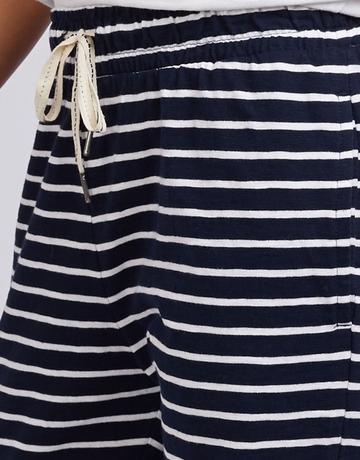 Close-up of Elm navy blue and white horizontally striped shorts with a cream-colored drawstring at the elastic waistband.