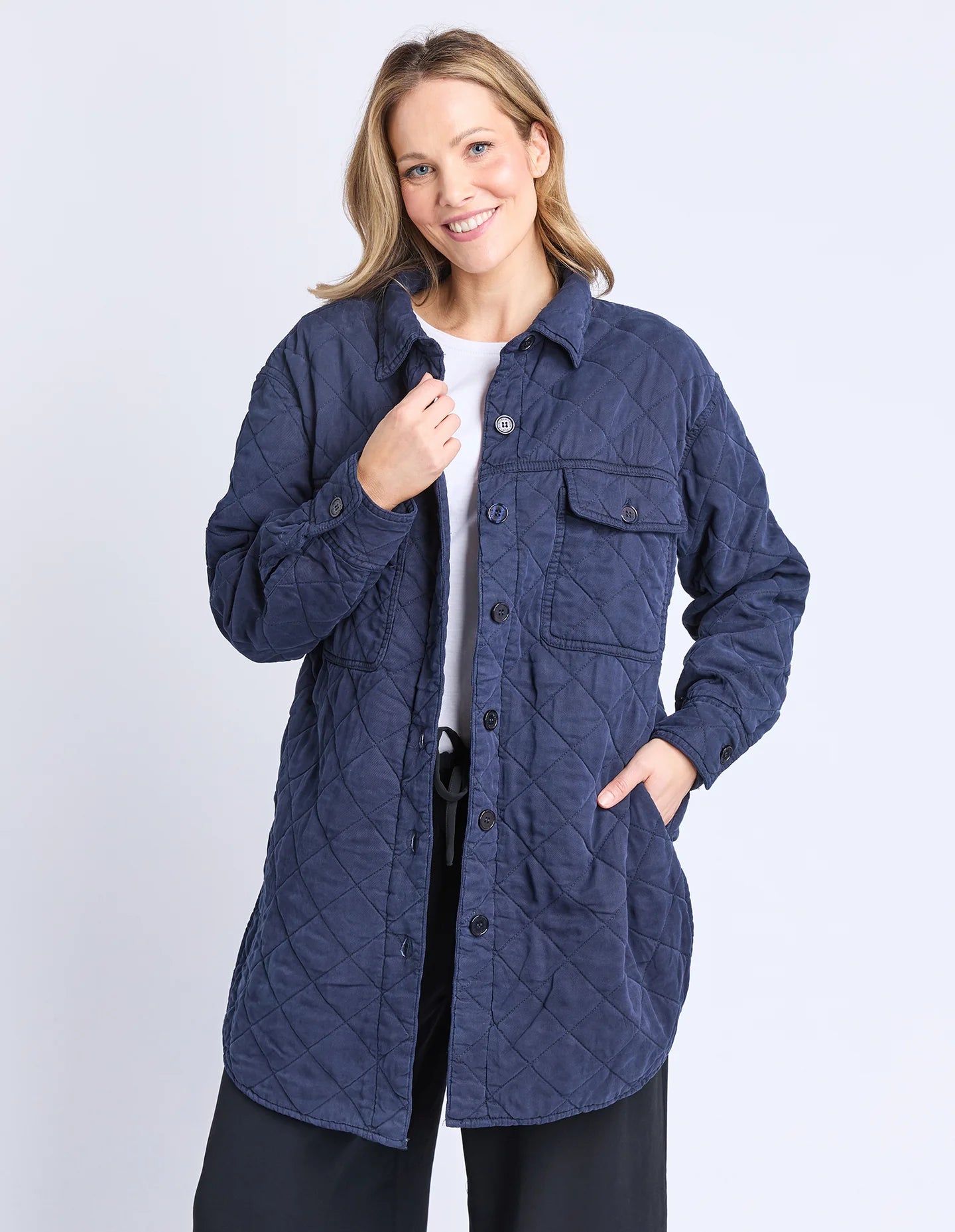 Image of Woman wearing a Elm blue quilted jacket on a white background