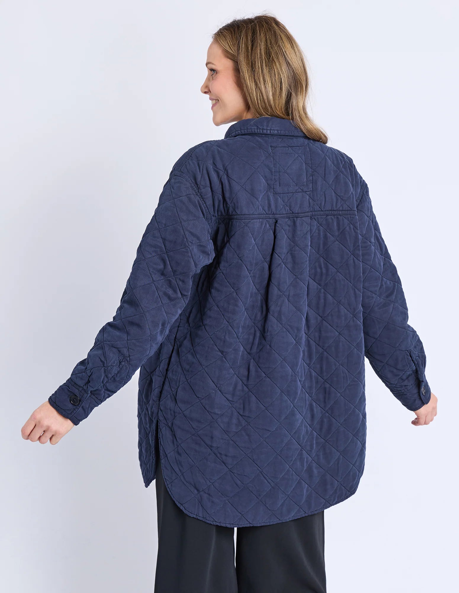 Image of Woman wearing a Elm blue quilted jacket on a white background