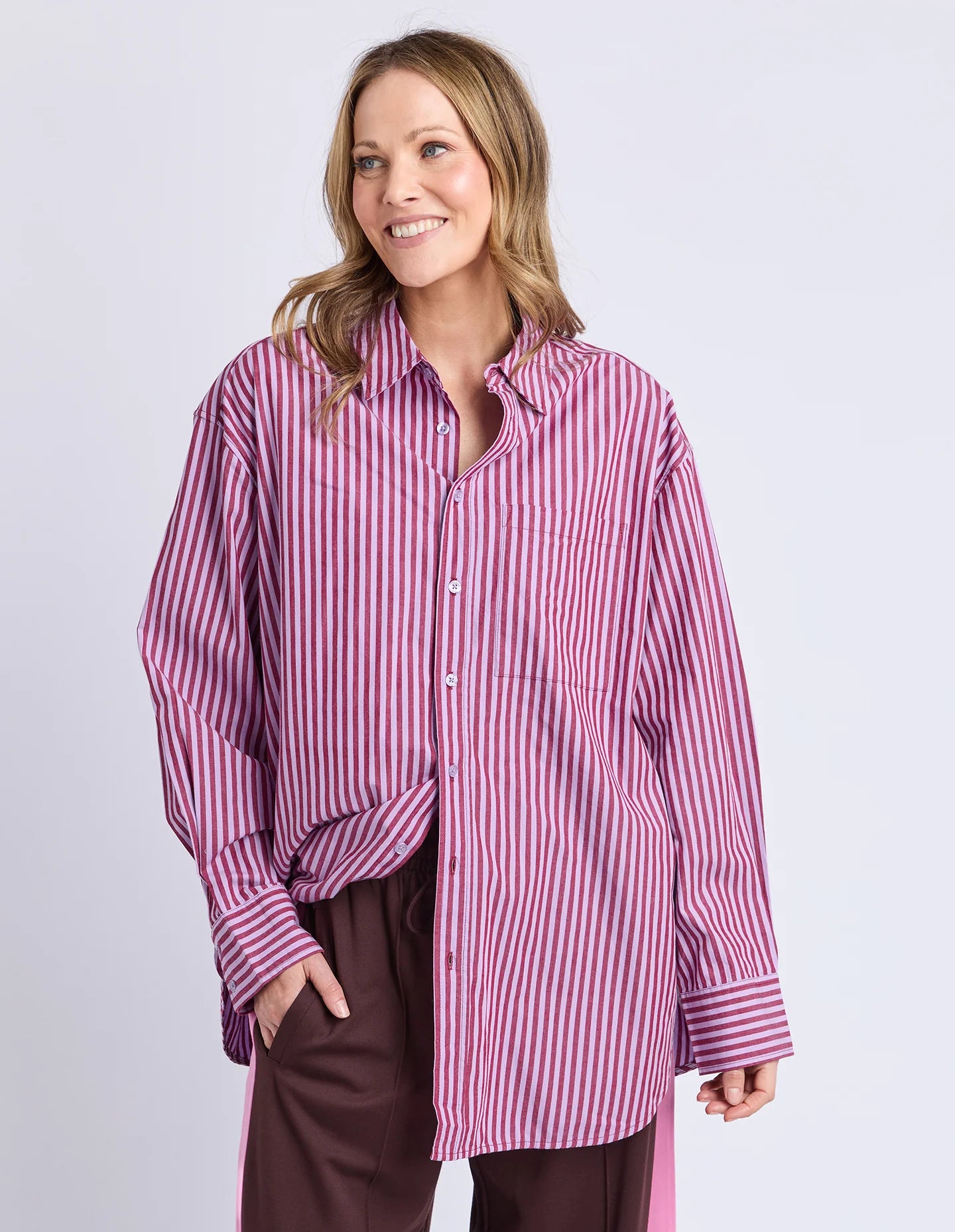 Image of Woman wearing a Elm pink and white striped shirt with a plain background